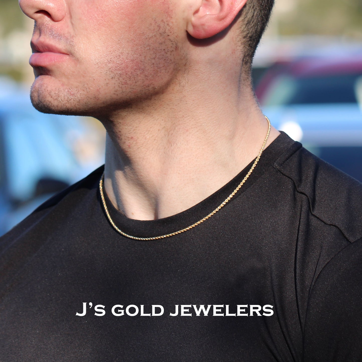 Man wearing a gold chain necklace with 'J's Gold Jewelers' branding.